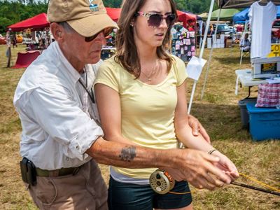 Man teaching a Woman how to Fly Fish